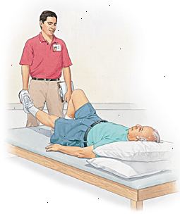 Ο άνθρωπος που βρίσκεται στο τραπέζι με το κεφάλι υποστηρίζεται από μαξιλάρια, αυξάνοντας το ένα πόδι. Πάροχος της υγειονομικής περίθαλψης στέκεται δίπλα στο τραπέζι. Ο άνθρωπος που βρίσκεται στο τραπέζι με το κεφάλι υποστηρίζεται από μαξιλάρια, αυξάνοντας το ένα πόδι. Πάροχος της υγειονομικής περίθαλψης στέκεται δίπλα στο τραπέζι.